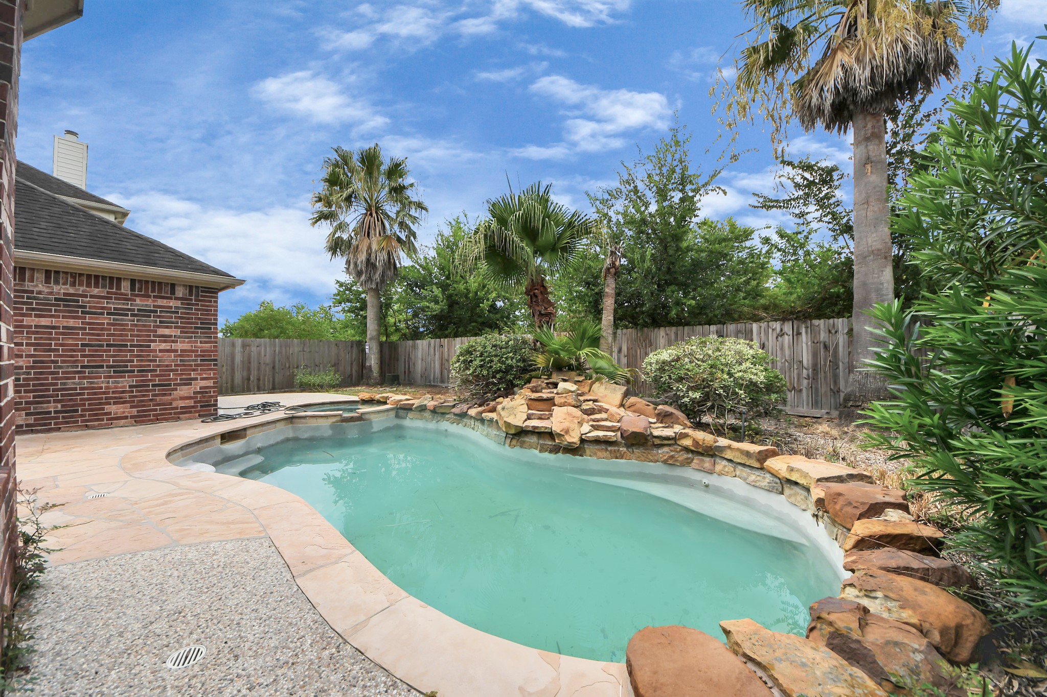 20011 Rosswood Lane Spring, TX 77388 - Photo 21 of 26 a view of a backyard with a garden and swimming pool