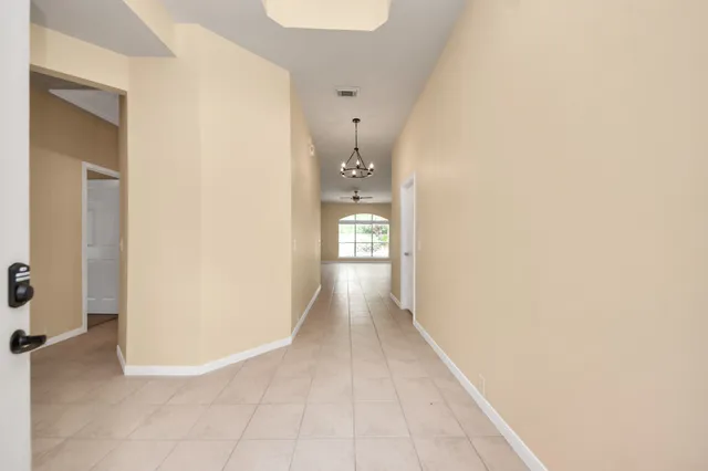 a view of a hallway with wooden shelves