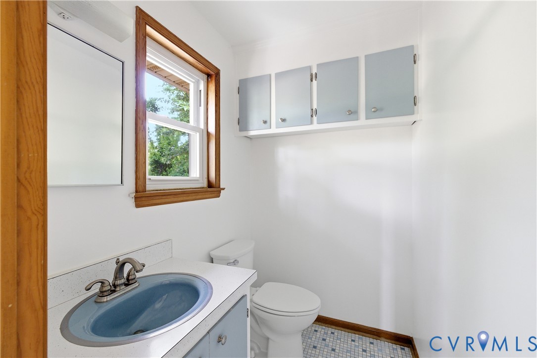 2713 Irwin Road Prince George, VA 23875 - Photo 16 of 26 a bathroom with a sink a toilet and a mirror