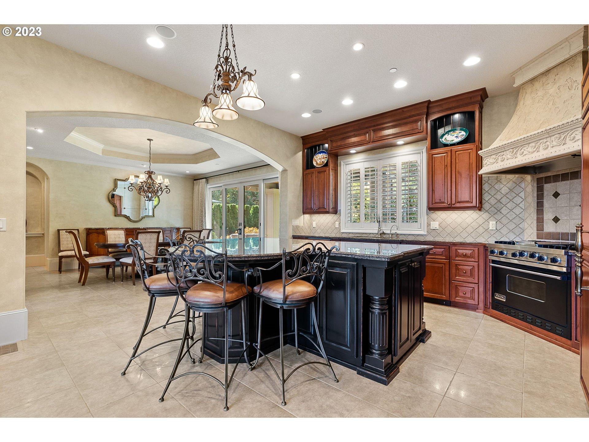 693 Southwest 68th Terrace Portland, OR 97225 - Photo 15 of 48 a kitchen with stainless steel appliances granite countertop dining table chairs and window