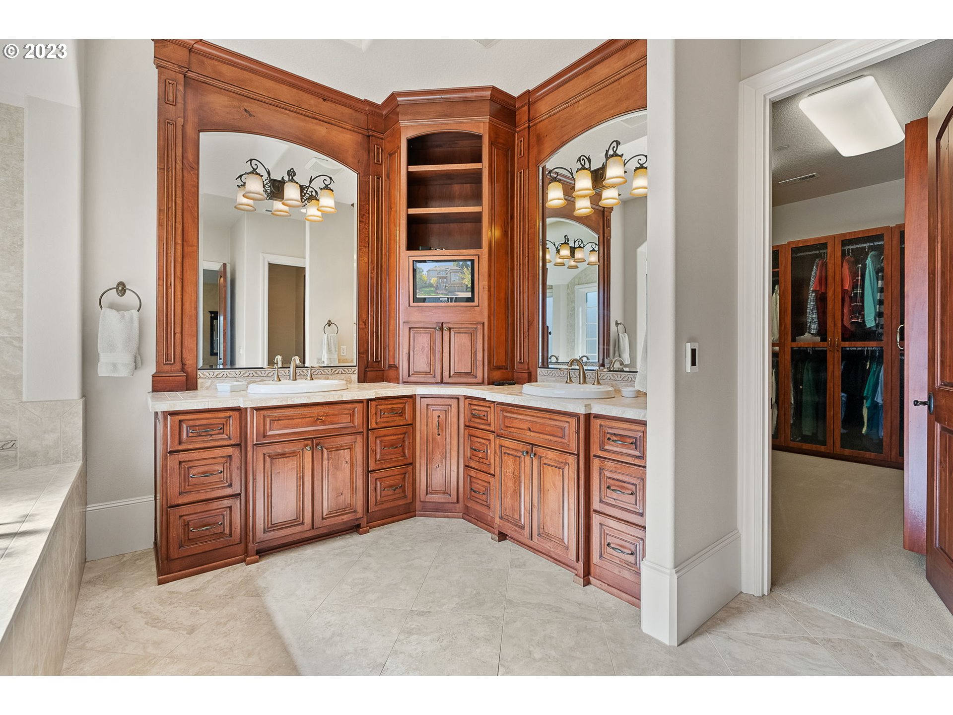 693 Southwest 68th Terrace Portland, OR 97225 - Photo 33 of 48 a large bathroom with a granite countertop sink mirror and a bathtub