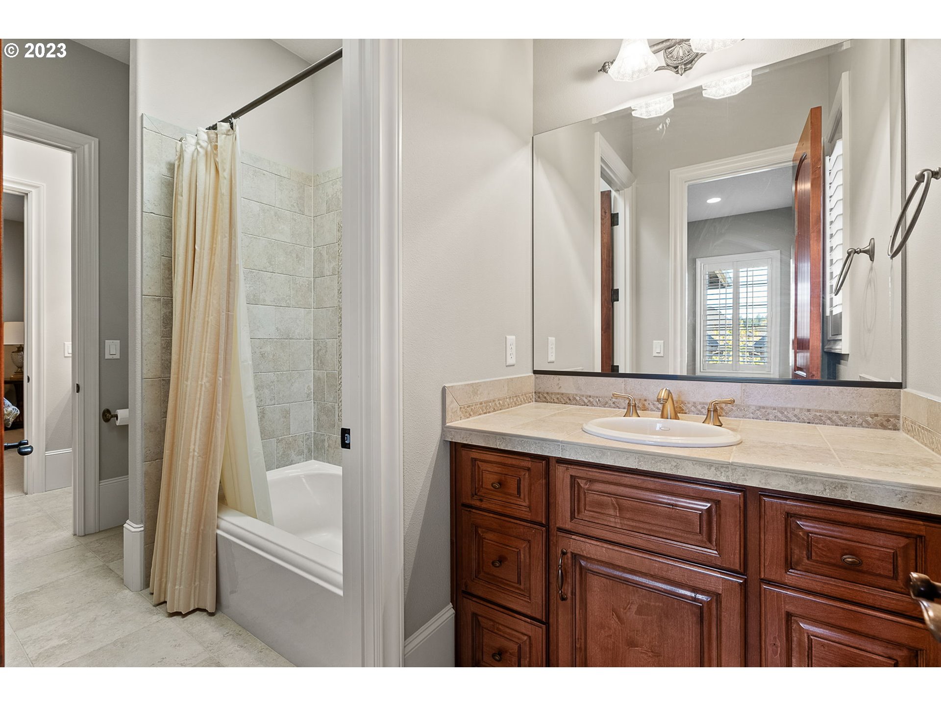 693 Southwest 68th Terrace Portland, OR 97225 - Photo 40 of 48 a bathroom with a granite countertop sink mirror and a bathtub