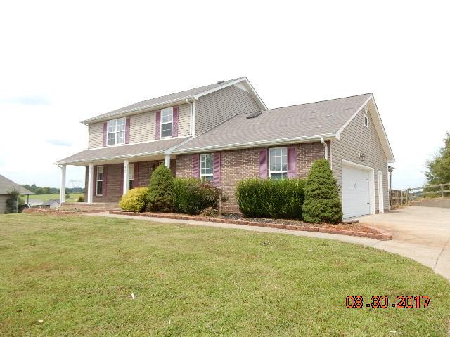 261 7 Mile Ferry Road Cunningham, TN 37052 - Photo 1 of 24 a front view of a house with a yard