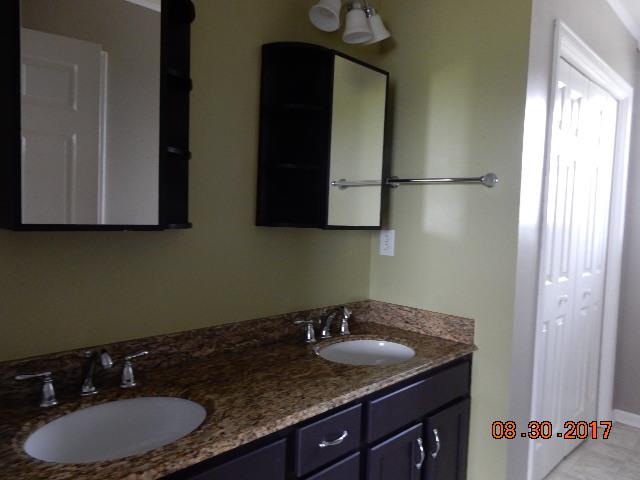 261 7 Mile Ferry Road Cunningham, TN 37052 - Photo 14 of 24 a bathroom with a granite countertop sink and a mirror