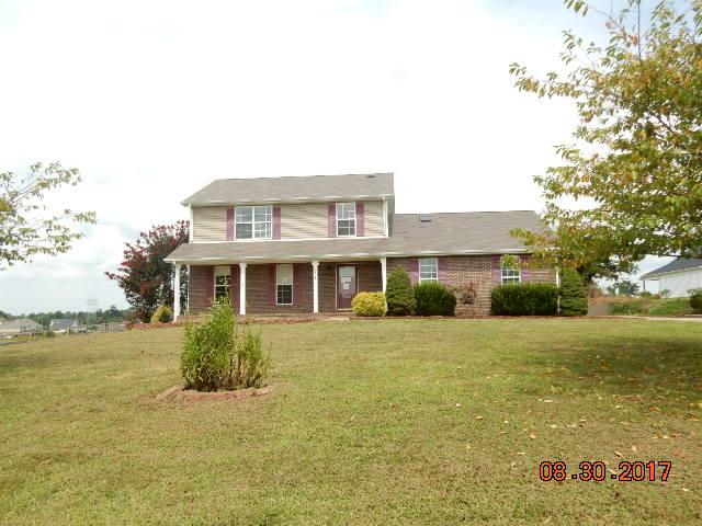 261 7 Mile Ferry Road Cunningham, TN 37052 - Photo 2 of 24 a front view of house with yard and trees in the background