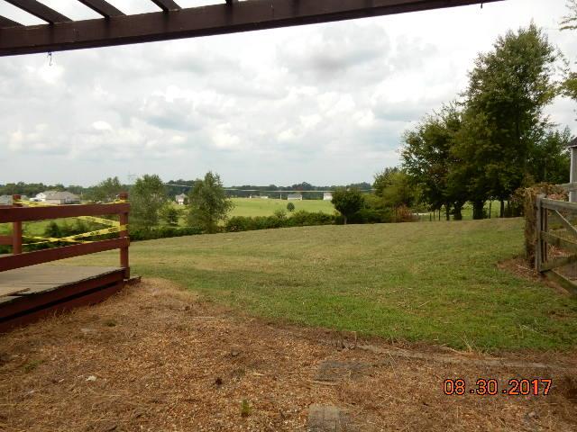 261 7 Mile Ferry Road Cunningham, TN 37052 - Photo 23 of 24 a view of a lake with houses in the back