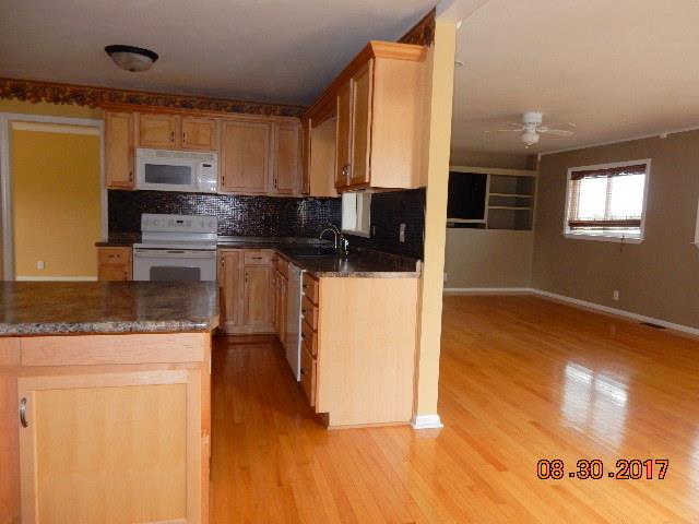 261 7 Mile Ferry Road Cunningham, TN 37052 - Photo 6 of 24 a kitchen with stainless steel appliances granite countertop a stove a sink and a microwave