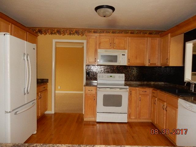 261 7 Mile Ferry Road Cunningham, TN 37052 - Photo 7 of 24 a kitchen with a refrigerator sink and cabinets