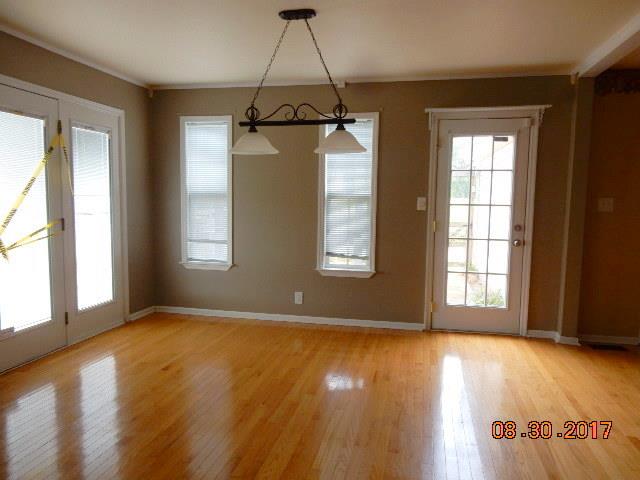 261 7 Mile Ferry Road Cunningham, TN 37052 - Photo 9 of 24 an empty room with wooden floor and windows
