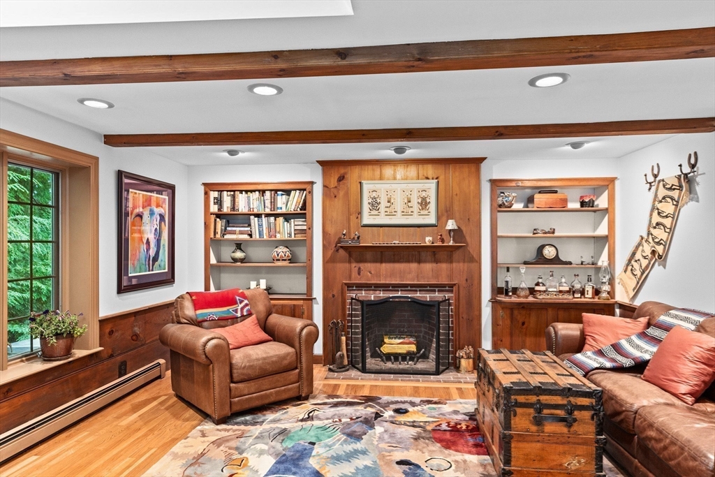 14 Camelot Drive Hingham, MA 02043 - Photo 11 of 34 a living room with furniture a flat screen tv and a fireplace