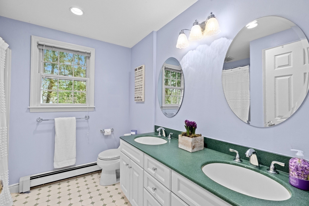 14 Camelot Drive Hingham, MA 02043 - Photo 23 of 34 a bathroom with a double vanity sink and a mirror