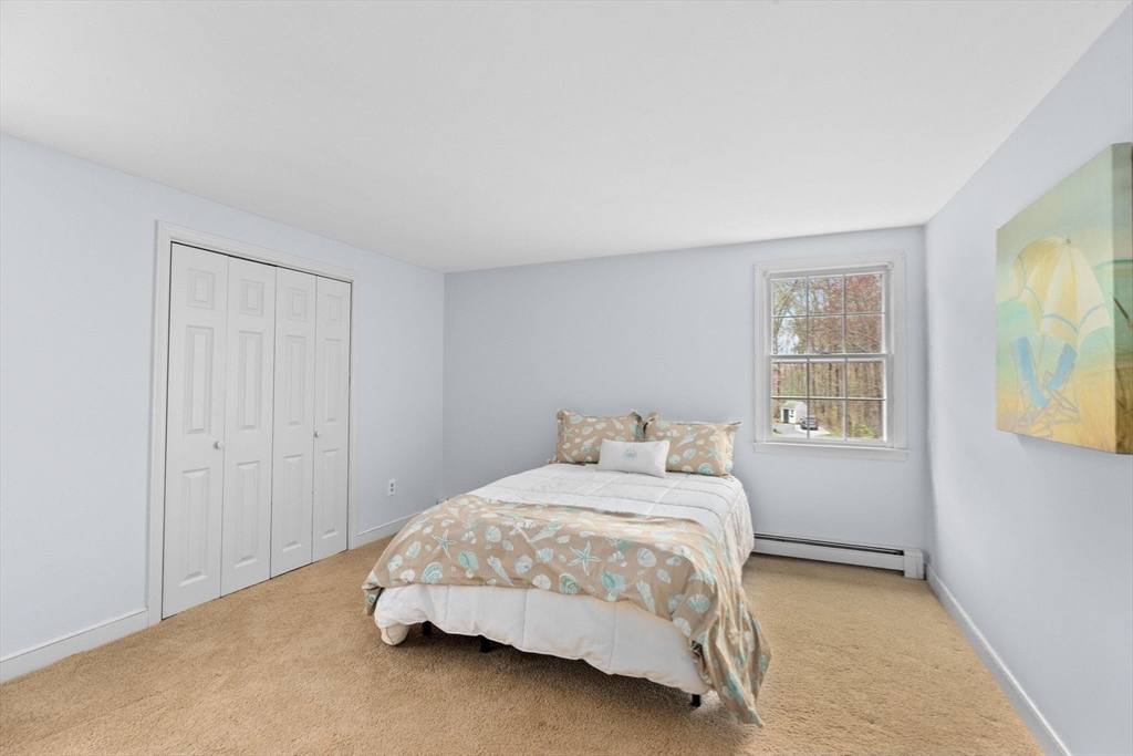 14 Camelot Drive Hingham, MA 02043 - Photo 26 of 34 a bedroom with a bed and painting on the wall