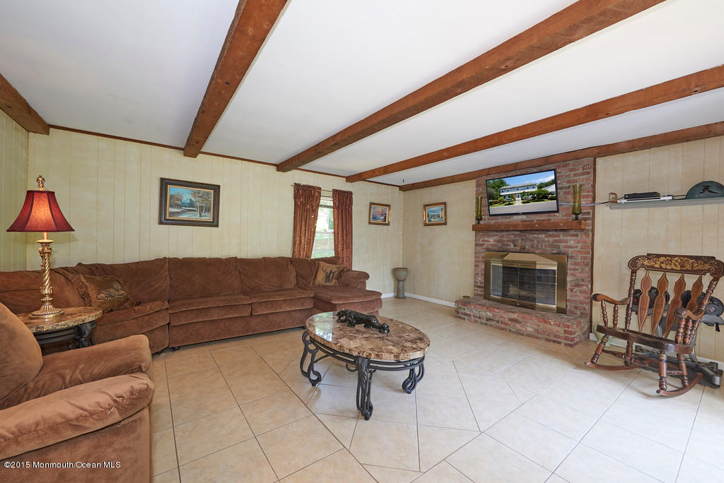 12 Bay Hill Road Middletown, NJ 07737 - Photo 18 of 30 a living room with furniture and a fireplace