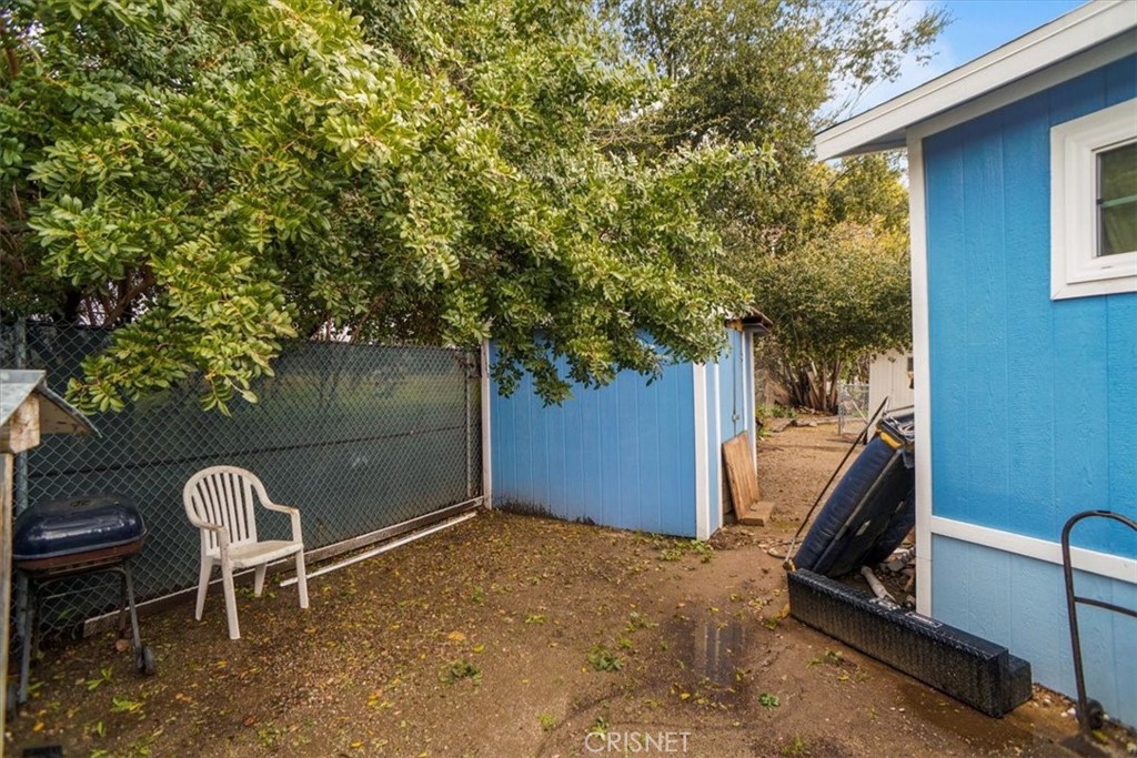 23830 Newhall Avenue, Unit 32 Newhall, CA 91321 - Photo 8 of 10 a backyard of a house with table and chairs