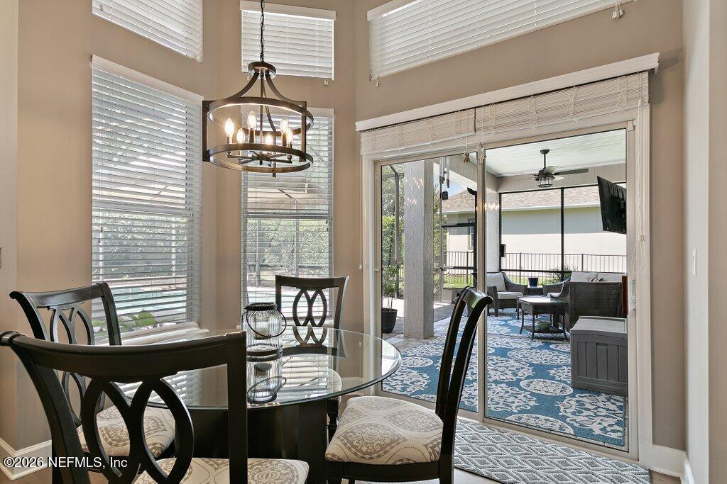 841 Ifield Road St. Augustine, FL 32095 - Photo 19 of 69 a view of a dining room with furniture wooden floor and a chandelier