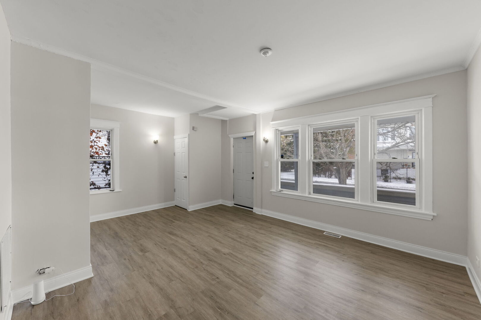 12012 South Michigan Avenue Chicago, IL 60628 - Photo 4 of 28 an empty room with wooden floor and windows