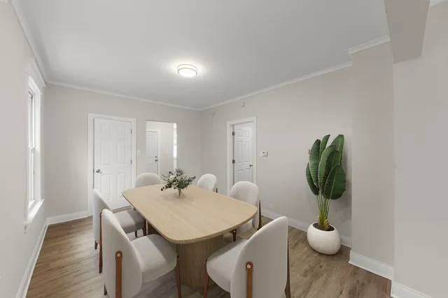 a view of a dining room with furniture and wooden floor