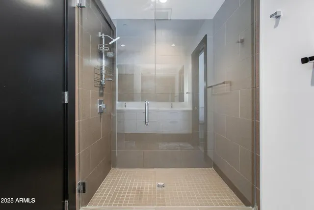 a bathroom with a glass shower door