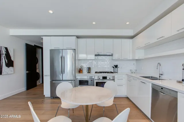 a kitchen with stainless steel appliances a refrigerator stove microwave and cabinets