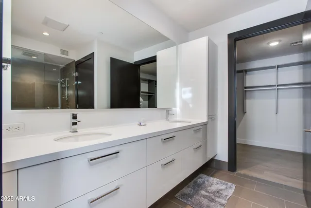 a bathroom with a double vanity sink and a mirror