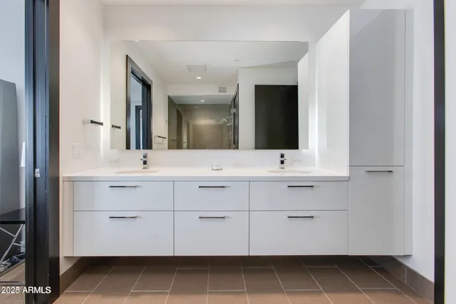 a bathroom with a sink vanity and mirror