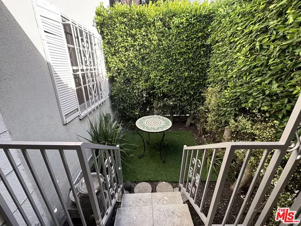 a balcony view with a sink and wooden floor