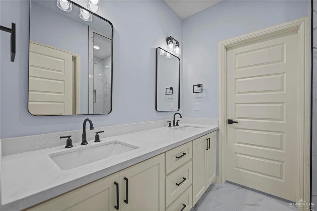 994 Rd Runner Street Rio Grande City, TX 78582 - Photo 12 of 17 a bathroom with a double vanity sink and mirror