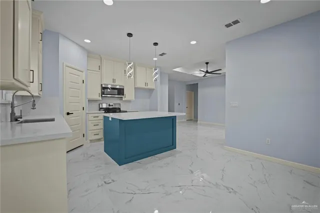 a view of a kitchen with refrigerator and a sink