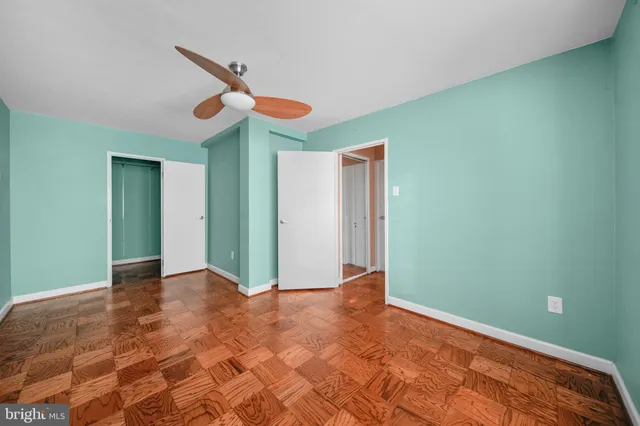 a view of a room with closet and chandelier fan