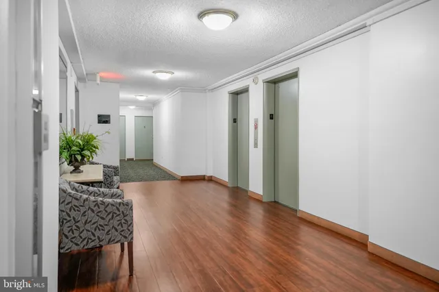 a view of a hallway and wooden floor