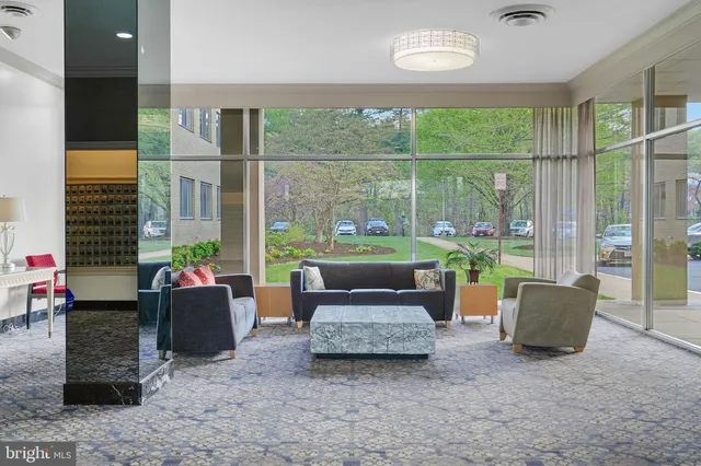 a living room with couch and a floor to ceiling window