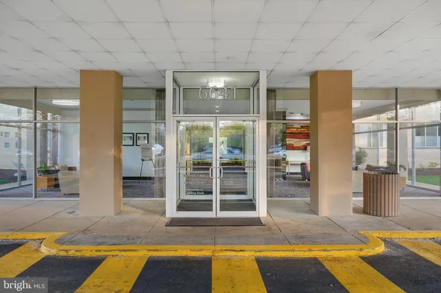 a view of spacious bathroom with a tub and door view