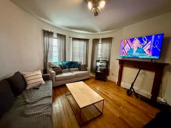 a living room with furniture and a flat screen tv