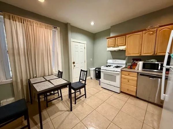 a kitchen with a stove a sink and a refrigerator