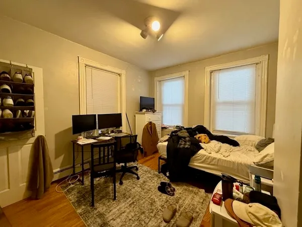 a bedroom with furniture and a window