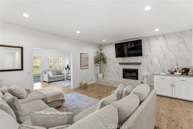 a living room with furniture a fireplace and a flat screen tv