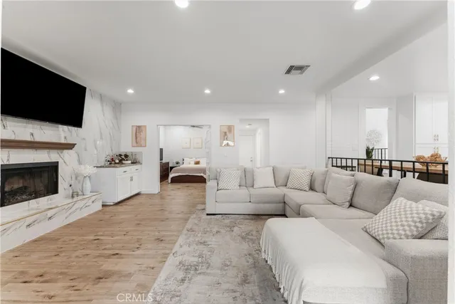 a living room with furniture a fireplace and a flat screen tv