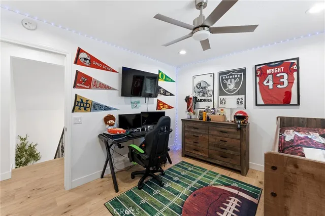 a work room with furniture and a flat screen tv