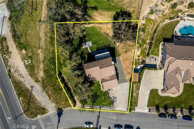 an aerial view of residential house with outdoor space and swimming pool
