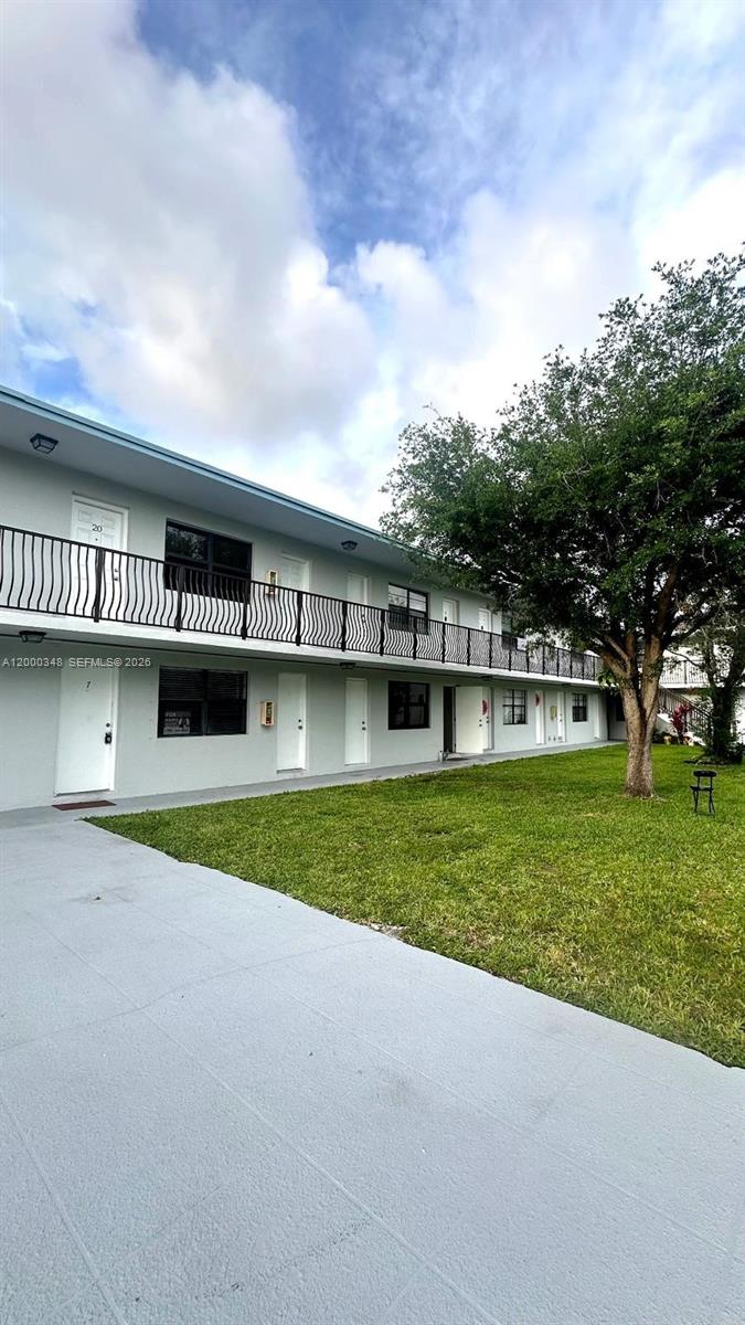 4444 Southwest 67th Avenue, Unit 6 Miami, FL 33155 - Photo 2 of 11 a view of a house with a yard and a garage