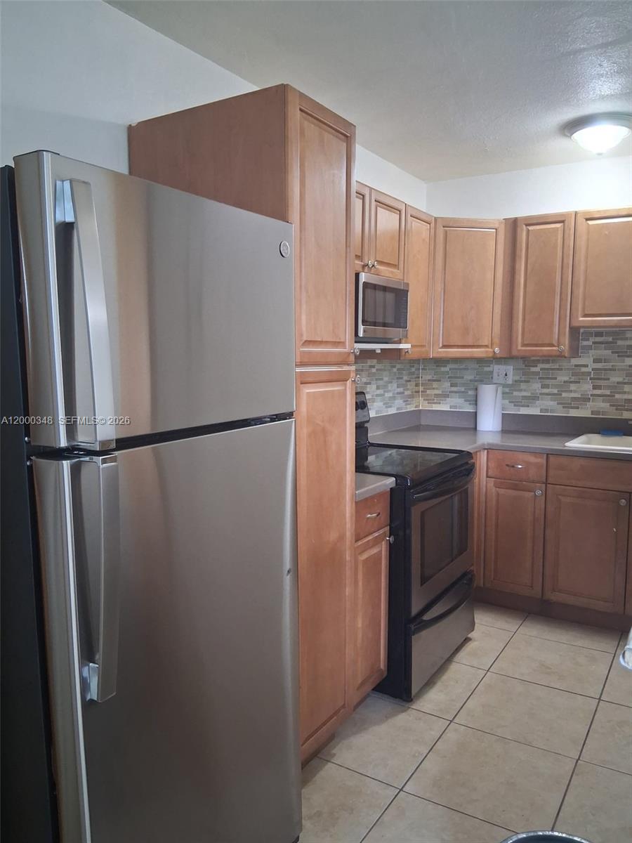 4444 Southwest 67th Avenue, Unit 6 Miami, FL 33155 - Photo 3 of 11 a kitchen with stainless steel appliances granite countertop a refrigerator sink and stove