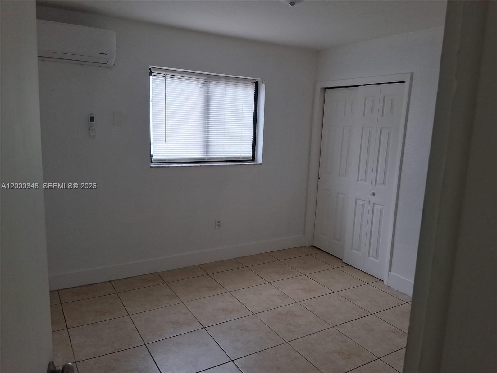 4444 Southwest 67th Avenue, Unit 6 Miami, FL 33155 - Photo 7 of 11 a view of an empty room with a window