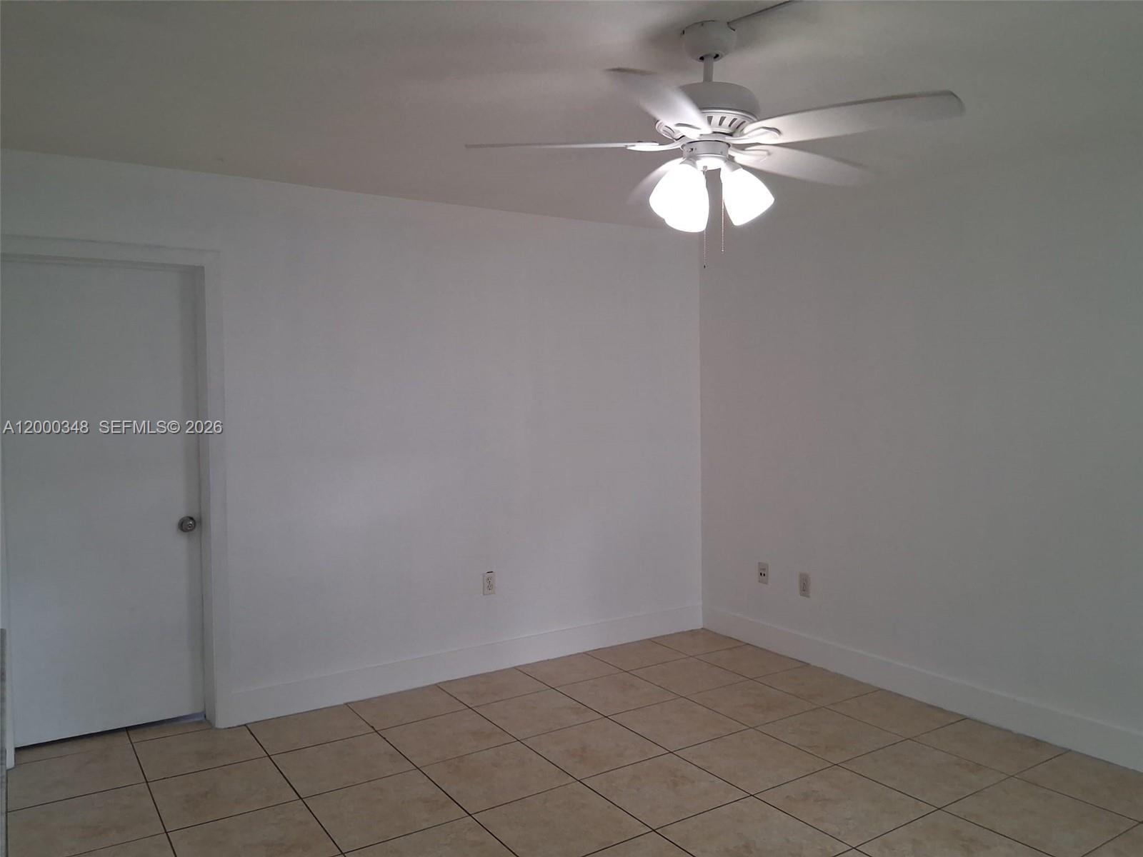 4444 Southwest 67th Avenue, Unit 6 Miami, FL 33155 - Photo 8 of 11 a view of an empty room with a chandelier fan