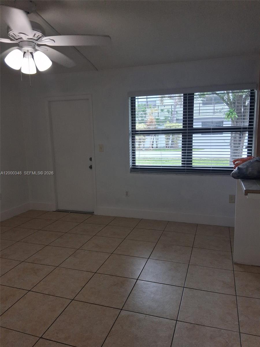 4444 Southwest 67th Avenue, Unit 6 Miami, FL 33155 - Photo 9 of 11 a view of an empty room with a window