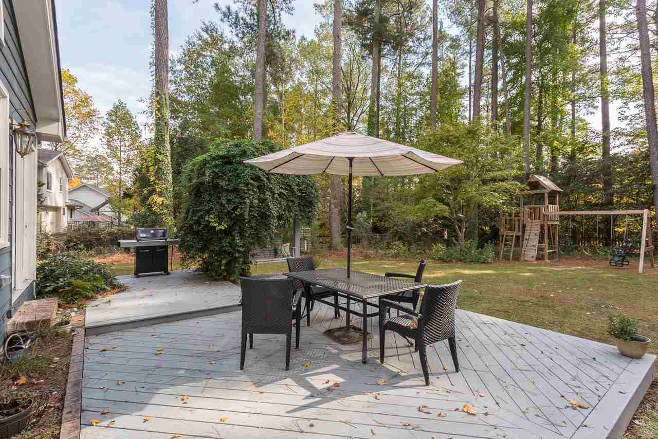 7608 Harps Mill Road Raleigh, NC 27615 - Photo 20 of 25 The deck offers a large area for outdoor dining, a place for a large grill, and a swing too! Deck off Sunroom
