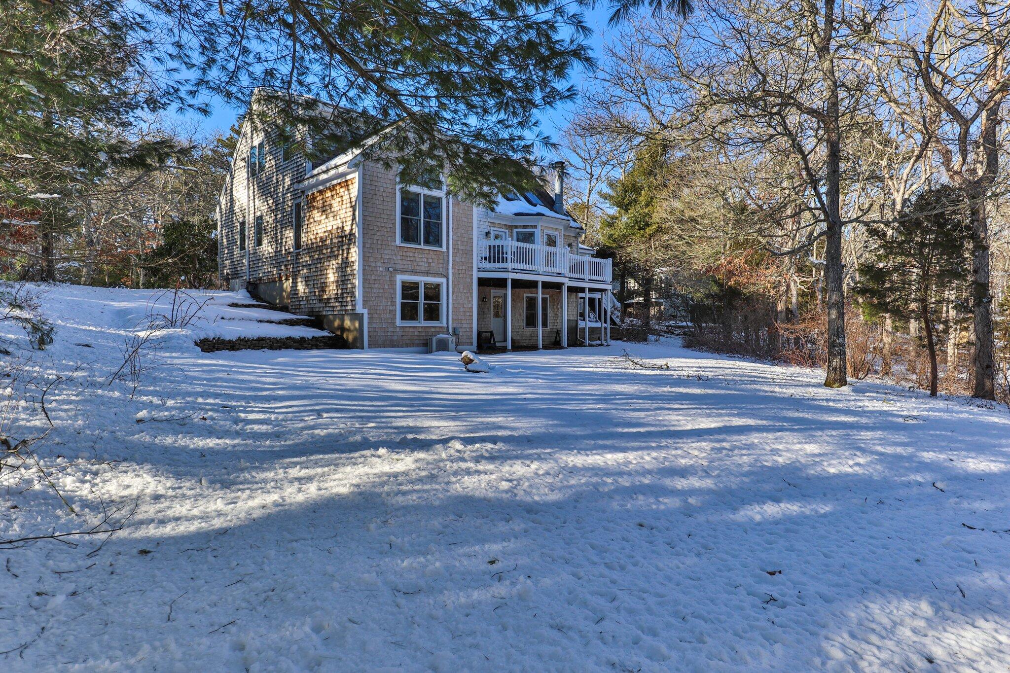 244 Santuit Road Cotuit, MA 02635 - Photo 58 of 58 a front view of house with yard and trees in the background