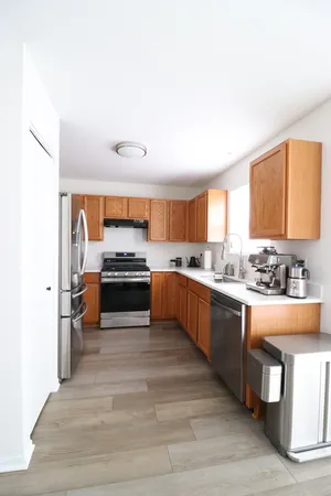 a kitchen with granite countertop a stove and a refrigerator
