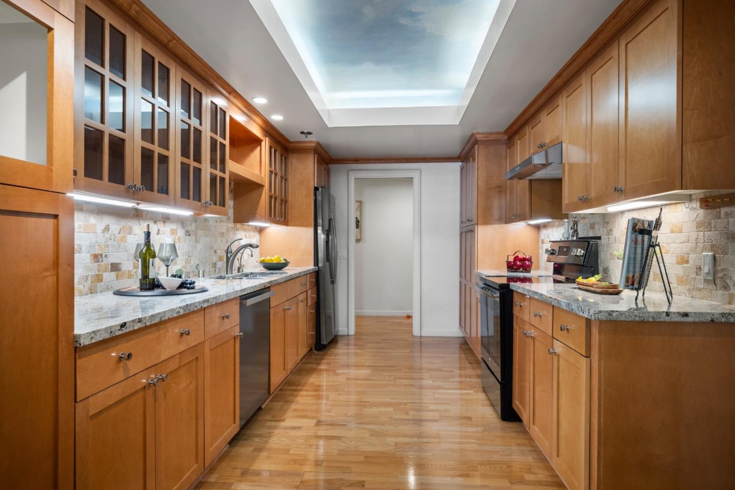 110 Park Road, Unit 103 Burlingame, CA 94010 - Photo 13 of 48 a kitchen with stainless steel appliances granite countertop a sink and cabinets