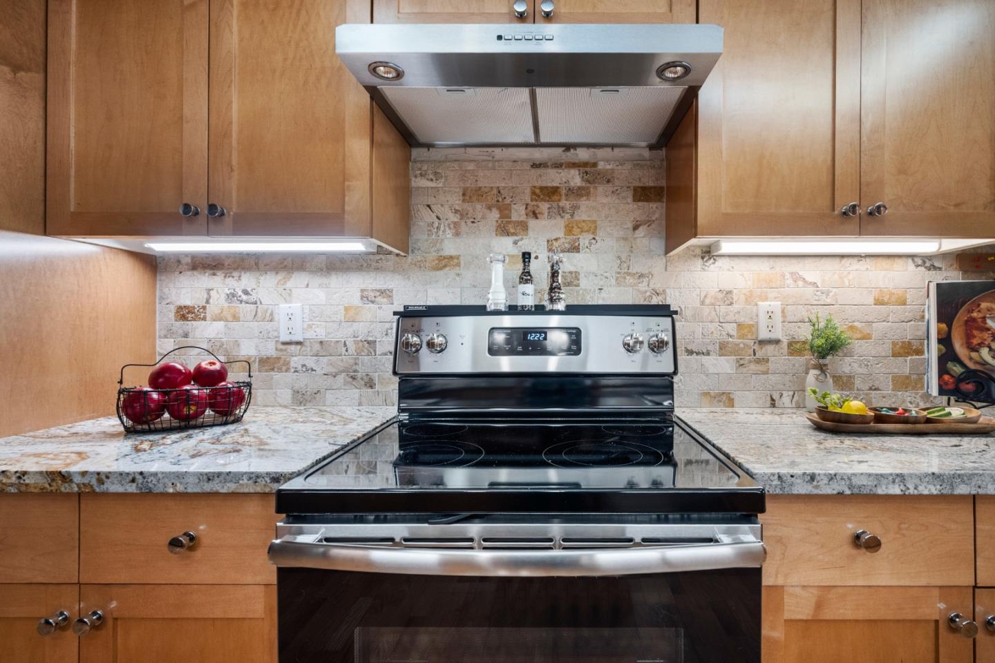 110 Park Road, Unit 103 Burlingame, CA 94010 - Photo 14 of 48 a stove top oven sitting inside of a kitchen