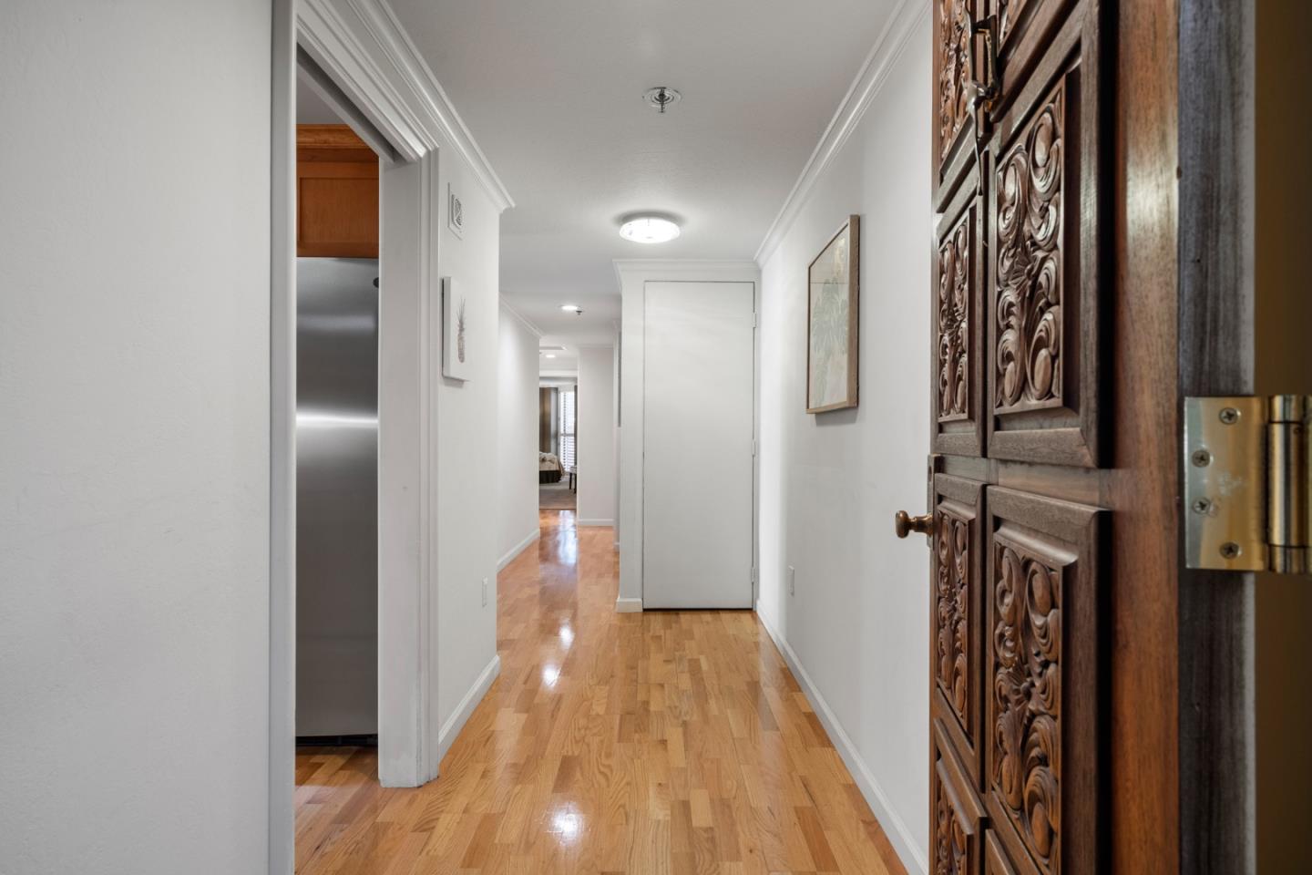 110 Park Road, Unit 103 Burlingame, CA 94010 - Photo 2 of 48 a view of a hallway with wooden floor and staircase